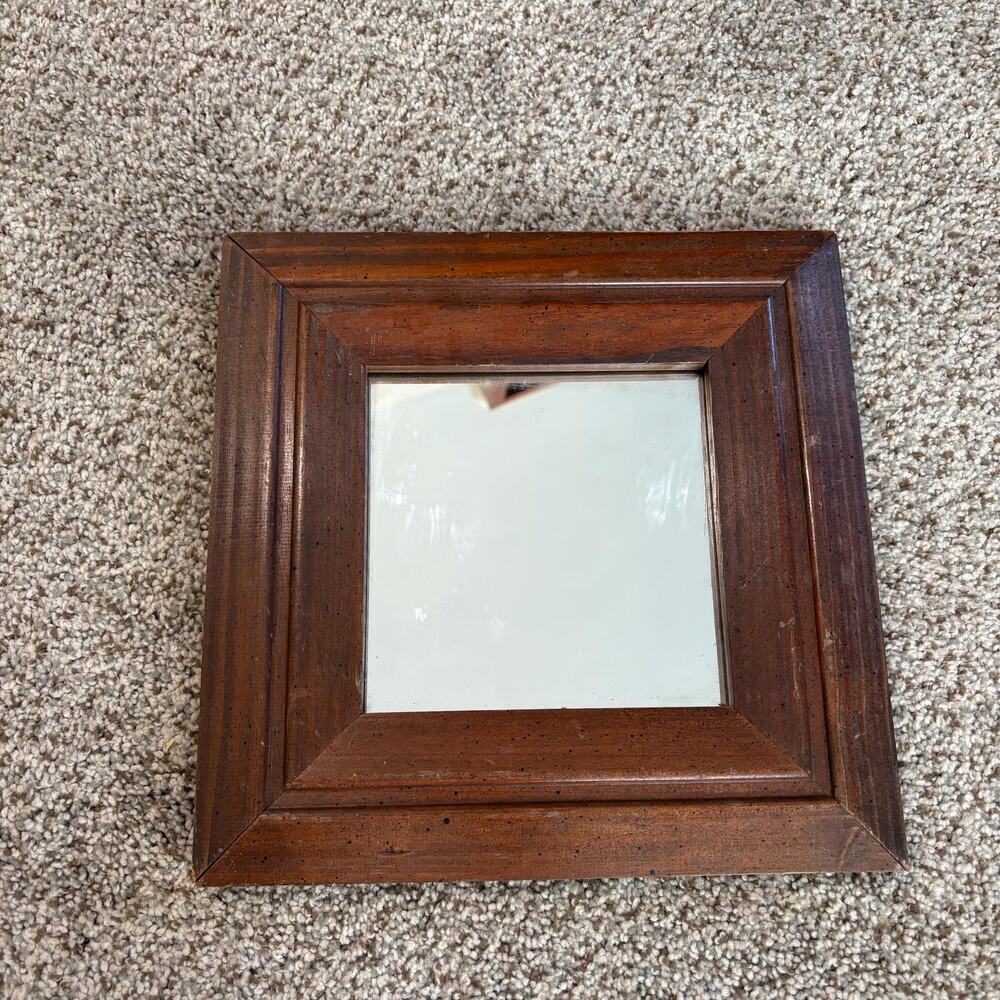 Vintage-style, square wall mirror features a thick, beveled solid wood frame